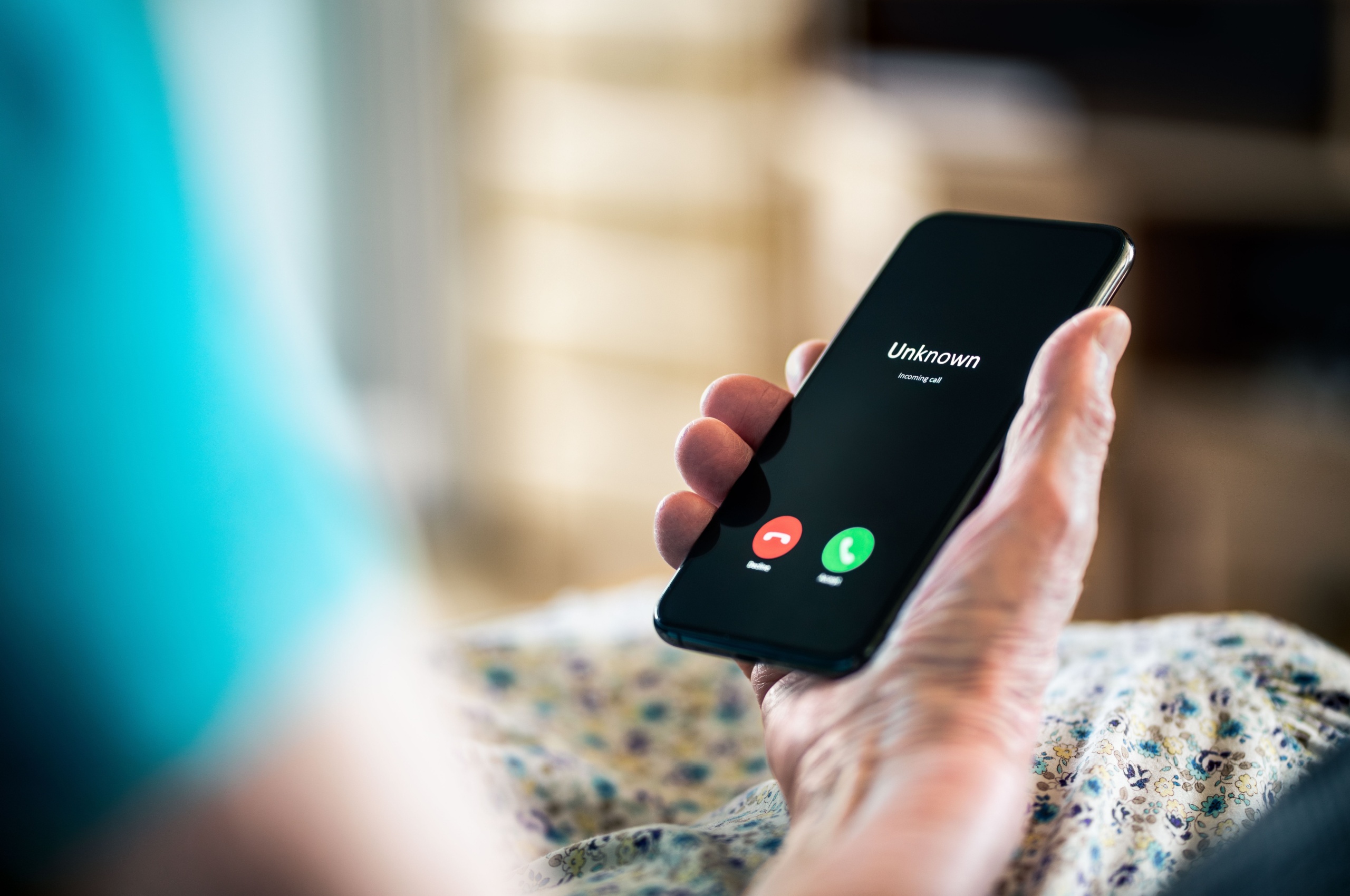 A person receiving a call from an unknown number.